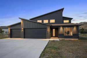 Contemporary house with an attached garage, board and batten siding, and driveway