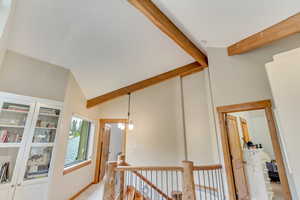 Hallway with an upstairs landing and light carpet