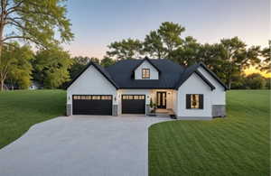 Modern inspired farmhouse featuring driveway, an attached garage, a lawn, and metal roof