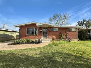 Beautiful brick rambler in a quiet neighborhood, close to shops, restaurants, and freeway. Single-car garage, planters with raspberry bushes and flowers, and completely remodeled interior.