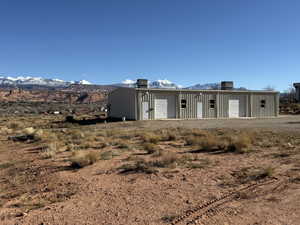 View of front facade with a mountain view, an outbuilding, and a workshop