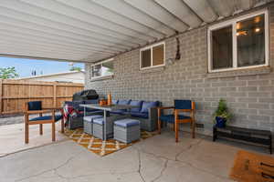 View of patio featuring an outdoor hangout area and fence