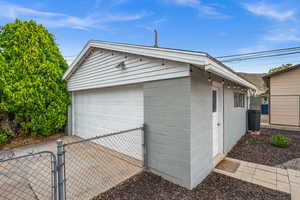 Detached garage with a gate and fence