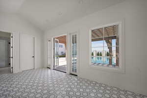 Unfurnished room with vaulted ceiling