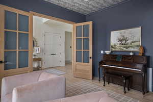 Living area featuring wood finished floors and ornamental molding