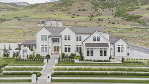 View of front of house with a standing seam roof, a mountain view, and metal roof