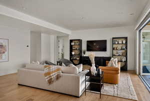 Living room featuring light wood-style flooring and recessed lighting