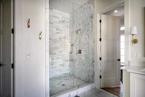 Full bath with a stall shower, vanity, and recessed lighting