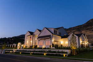 View of front of house featuring a mountain view and a front lawn