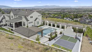 Aerial view of residential area with a pool and mountains