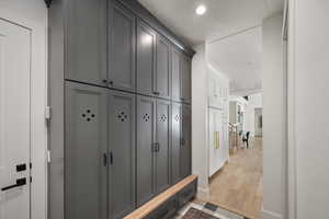 Mudroom featuring baseboards, recessed lighting, and light wood finished floors