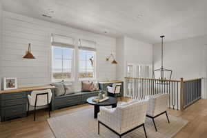 Living room with healthy amount of natural light, light wood-type flooring, and a textured ceiling