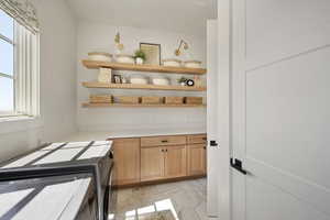 Laundry area featuring cabinet space, washer and dryer, and plenty of natural light