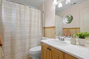 Full bathroom with toilet and vanity