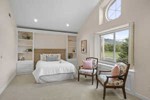 Primary suite (bedroom 4) with sitting area, built in headboard and storage, views of the mountains