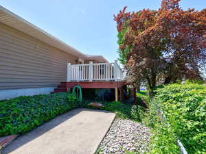 View of yard with a deck, stairway, and a patio area