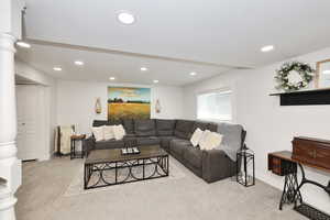 Living room featuring carpet, recessed lighting, baseboards, and ornate columns