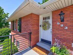 Doorway to property featuring brick siding