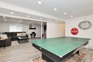 Recreation room with recessed lighting, light wood-style floors, and baseboards