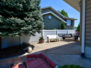 View of patio featuring fence