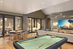 Recreation room featuring light wood-style floors, recessed lighting, pool table, vaulted ceiling, and wood walls