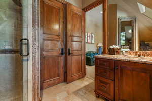 Bathroom with a stall shower, ensuite bath, vanity, and stone finish floors