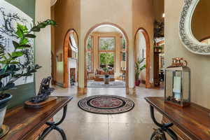 Vaulted ceiling entry with travertine tile