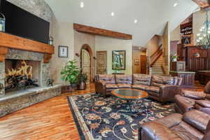 Great room with vaulted ceilings, arched doors, stone wood/gas burning fireplace