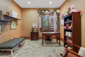 Office with marble look tiles and recessed lighting