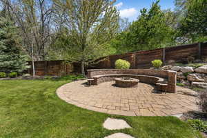 View of patio with an outdoor fire pit