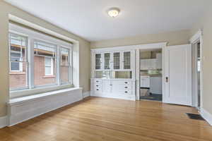 Dining room with light wood-type flooring and baseboards