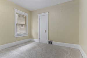 Bedroom featuring carpet floors and baseboards