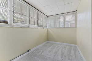 Spare room featuring carpet floors and baseboards
