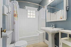 Bathroom with toilet and shower / bath combo