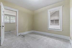 Carpeted room with baseboards