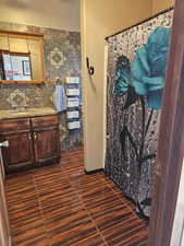 Bathroom featuring vanity, wood finished floors, and a shower with shower curtain