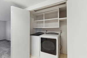 Clothes washing area with washer and clothes dryer and baseboards