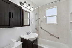 Full bath featuring shower / bath combination, toilet, and vanity