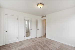 Unfurnished bedroom with carpet and baseboards