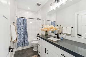 Bathroom with vanity and shower / bathtub combination with curtain