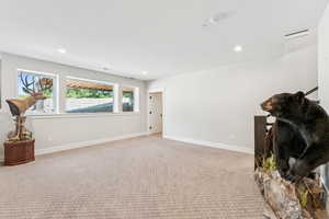 Interior space featuring light carpet and recessed lighting