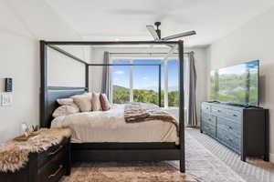 Bedroom featuring light colored carpet and ceiling fan