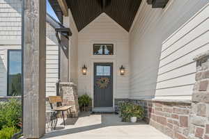 View of exterior entry with covered porch