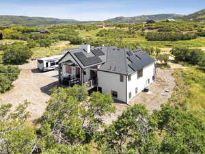 Aerial view of property and surrounding area featuring mountains
