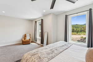 Carpeted bedroom with recessed lighting and ceiling fan