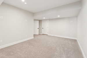 Spare room with recessed lighting and light colored carpet