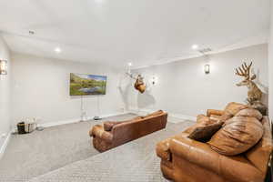 Carpeted home theater room with baseboards and recessed lighting