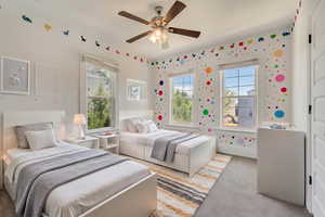 Bedroom with light colored carpet and a ceiling fan