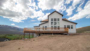 Back of house featuring a deck with mountain view
