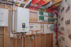Utility room with water heater and electric panel